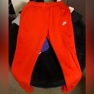 Red orange nike joggers
